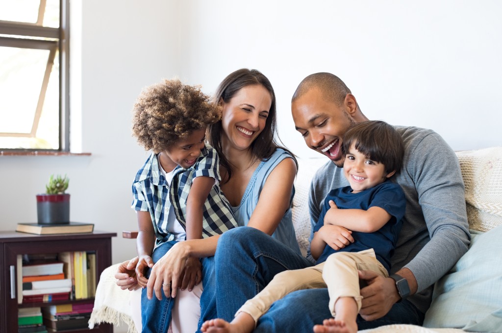 Family having fun on their couch at home
