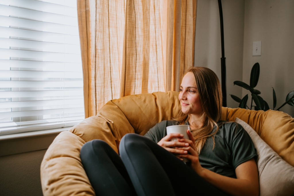 Woman relaxing at home with a mug