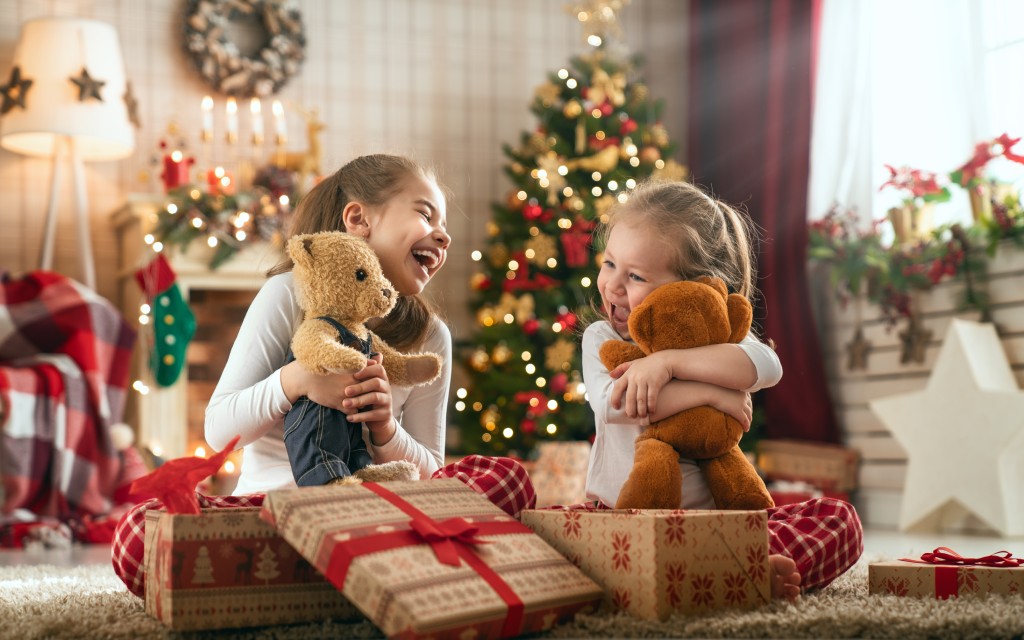 Young girls opening christmas gifts