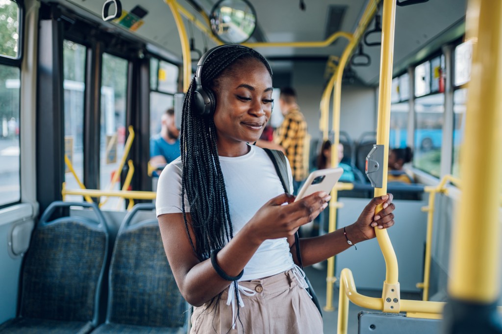 Woman using smartphone while riding a bus