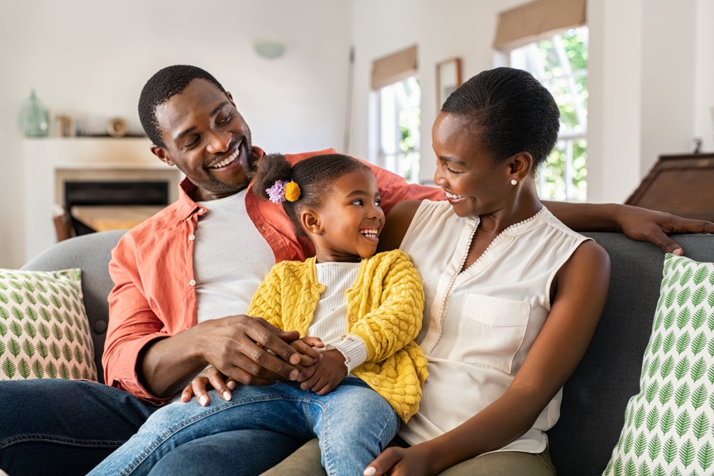 A happy family spends time together at home after rebuilding their credit.