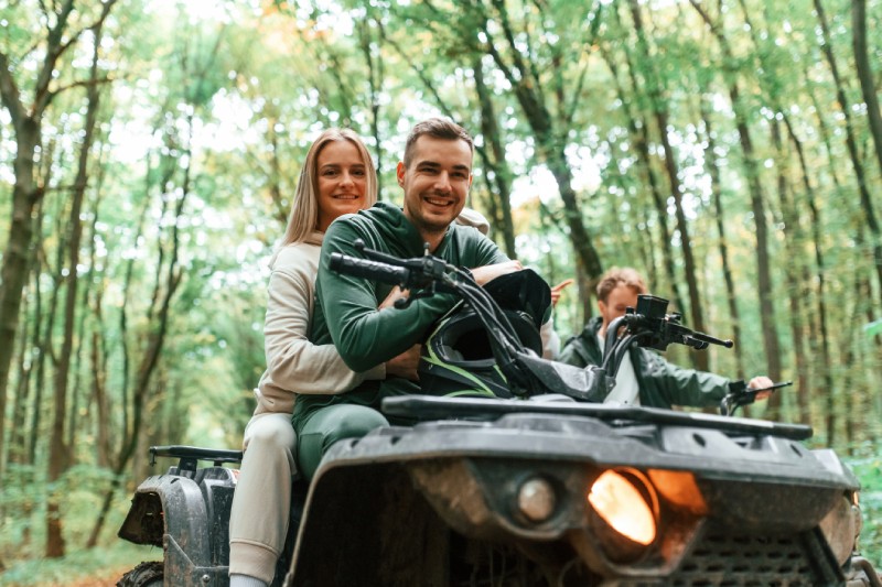 A couple sit proudly on their ATV